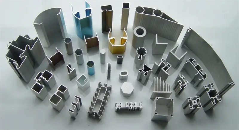 Assorted aluminum extrusion cross sections showing differences in profile geometry and surface appearance